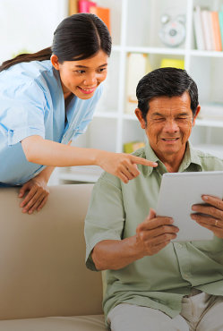 a woman and a man holding a tablet